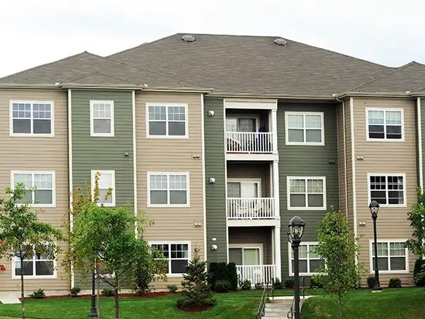Apartment building with a brown shingle roof
